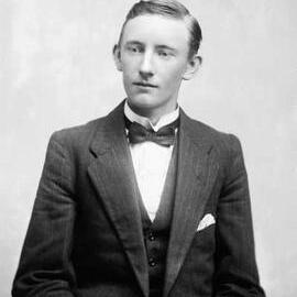 Studio portrait of a young man wearing a suit.  Family name Duffy.