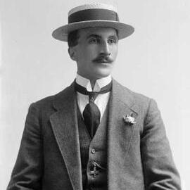 Studio portrait of a man wearing a boater hat.