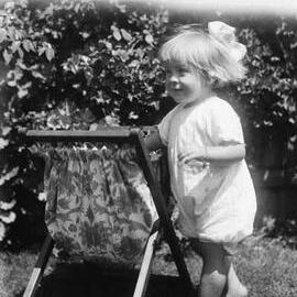 An unidentified young girl playing in an outdoor location.