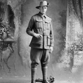 Studio portrait of a young man wearing an Australian Army uniform.  Family name Doughtey.