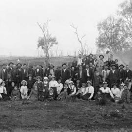 An unidentified group of people relaxing in a farmland environment.