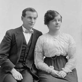 Portrait of a seated man and woman.