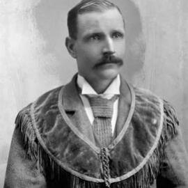 Studio portrait of Mr. Greenham wearing a velvet fringed stole or vest of unknown symbolism.