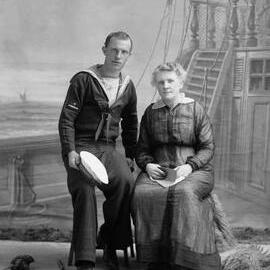 Portrait of a woman with a man in a sailors uniform.  Family name Baxter.
