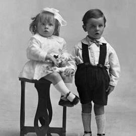 Studio portrait of a young girl and boy.   Family name possibly Rine.