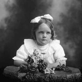 Half-length studio portrait of a girl.   Family name Carmody.