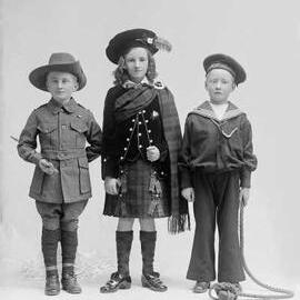 Studio portrait of  group of three children in costume.   Family name Gray.