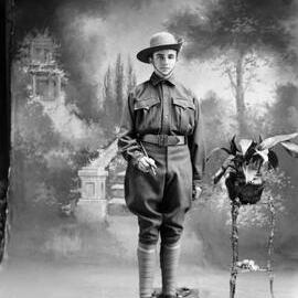 Studio portrait of a young man, family name Cronan, in a cadet army uniform.