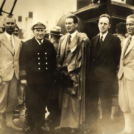 Group of men standing on deck