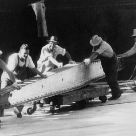 Wharf labourers handling a steel hatch beam on the Melbourne waterfront in 1962.