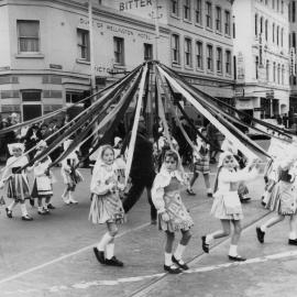 A may pole featuring young girls, during a May Day March in Melbourne.