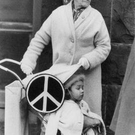 An elderly woman and a young child in a pusher, at a peace rally in Melbourne.
