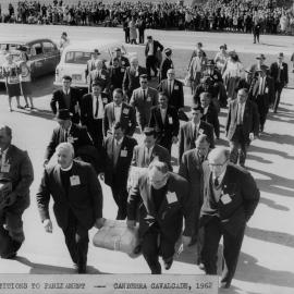 A group of men at Parliament House, Canberra presenting Peace Petitions to Parliament, during the "Canberra Cavalcade" in 1962.