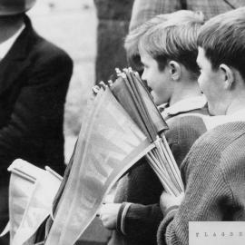 Young boys selling flags in Melbourne on May Day.