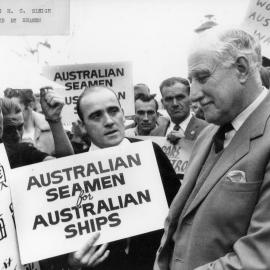 Australian seamen at North Wharf in Melbourne holding protest placards in front of Hamilton Sleigh, Chairman of H. C. Sleigh Limited.