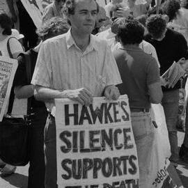 "Hawkes silence supports the death sounds" banner at El Salvador march to U.S. consulate offices, November 1990.