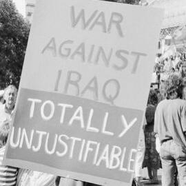 "War against Iraq totally unjustifiable" poster outside U.S. consulate during Persian Gulf war protest, 14 January 1991.