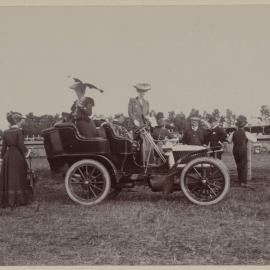 Women watching car racing at a motor club gymkhana at Maribyrnong, Victoria