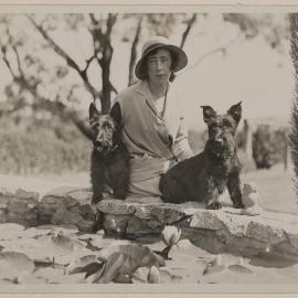 [Mab and her Scottish Terriers seated at lily pond,] Westerfield