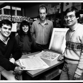 Deacon, Dr Nick, with Dr Damien Purcell, Ms Russell, and Mr Hooker with charts which form part of a report to international colleagues...