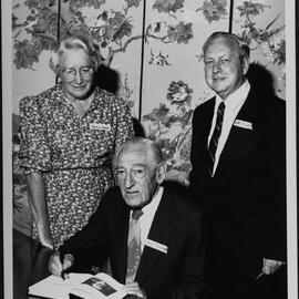 Goldberg, Professor Emeritus Louis, signing a copy of ‘Essays in Honour of Louis Goldberg’ launched at University House. Included are Miss Jean Kerr, former Reader in Accounting and Dr Bob Clift, Reader in Accounting, who edited the essays