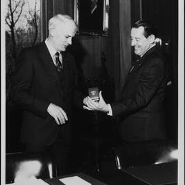 Pawsey, Maurice showing medal to J B. Potter