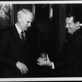 Pawsey, Maurice showing medal to J B. Potter