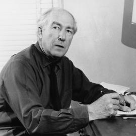 Portrait of the poet A.D. Hope writing at a desk.