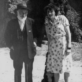 Sydney Jephcott and Elyne Mitchell standing together in a garden.