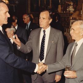 The Vice President of the United States George Bush introducing an unidentified man to Malcolm Fraser during the Prime Minister's official visit to Washington USA in May 1982.