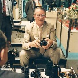 Malcolm Fraser examining a camera during a visit to Japan.