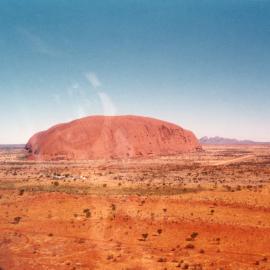 An aerial view of Uluru (Ayres Rock) with Katajuta (The Olgas) in the background.