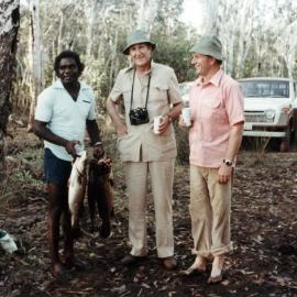 Malcolm Fraser relaxing with Galarrwuy Yunupingu, Chair of the Northern Land Council, and others after a fishing trip in the Northern Territory.