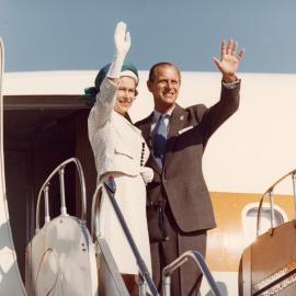 Queen Elizabeth II and the Duke of Edinburgh waving as they board an aircraft at Perth Airport on their departure from Australia following their 1977 official visit.