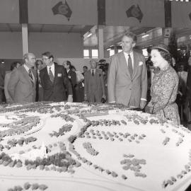 Malcolm Fraser and Queen Elizabeth II examining a landscape model in the Royal Exhibition Building in Melbourne.