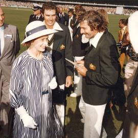 Queen Elizabeth II with cricketers Dennis Lillee and Greg Chappell at the Centenary Cricket Test at the Melbourne Cricket Ground during her 1977 official Australian visit.
