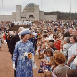 Queen Elizabeth II greeting children at the dedication of a memorial for the Royal Regiment of Australian Artillery in Canberra during her 1977 official visit to Australia.