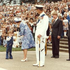 Queen Elizabeth II receiving a bouquet of flowers from a small boy in Canberra at the commencement of her1977 official visit to Australia.
