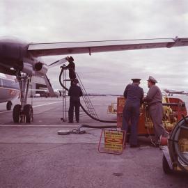 Aircraft refuellers using Shell pumping equipment to refuel an Ansett-ANA Fokker F27 Friendship