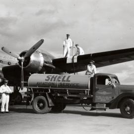 A Shell Aviation Service International pump tanker refuelling a Douglas DC-6B aircraft