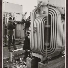 Workman at  flue duets at main boiler plant.