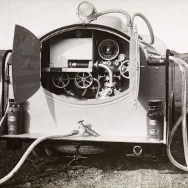 The rear view of a Ford Sussex pump tanker with doors open showing the pump and hose