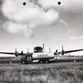 A Shell pump tanker with two men refuelling a possible Ansett-ANA or Trans Australian Airlines, U