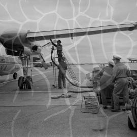 An Ansett-ANA Fokker F27 Friendship being refuelled by Shell Australia workers on the apron of an unidentified Australian airport
