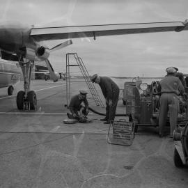An Ansett-ANA Fokker F27 Friendship being refuelled by Shell Australia workers on the apron of an unidentified Australian airport.