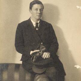 Alice Anderson in chauffeur uniform holding her cap and gloves