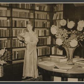 Louise Dyer standing in her personal library