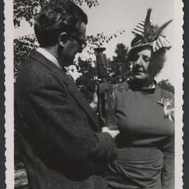 Jeff Hanson and Louise Hanson-Dyer standing outside holding and inspecting a small sculpture