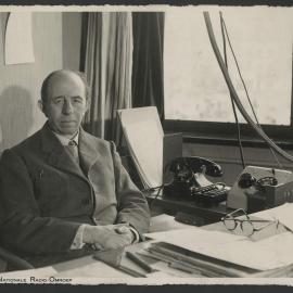 Musicologist Paul Collaer seated at his desk at the Belgian National Radio