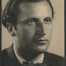Promotional headshot of Bulgarian composer Boyan Ikonomov wearing a dark suit with bow tie